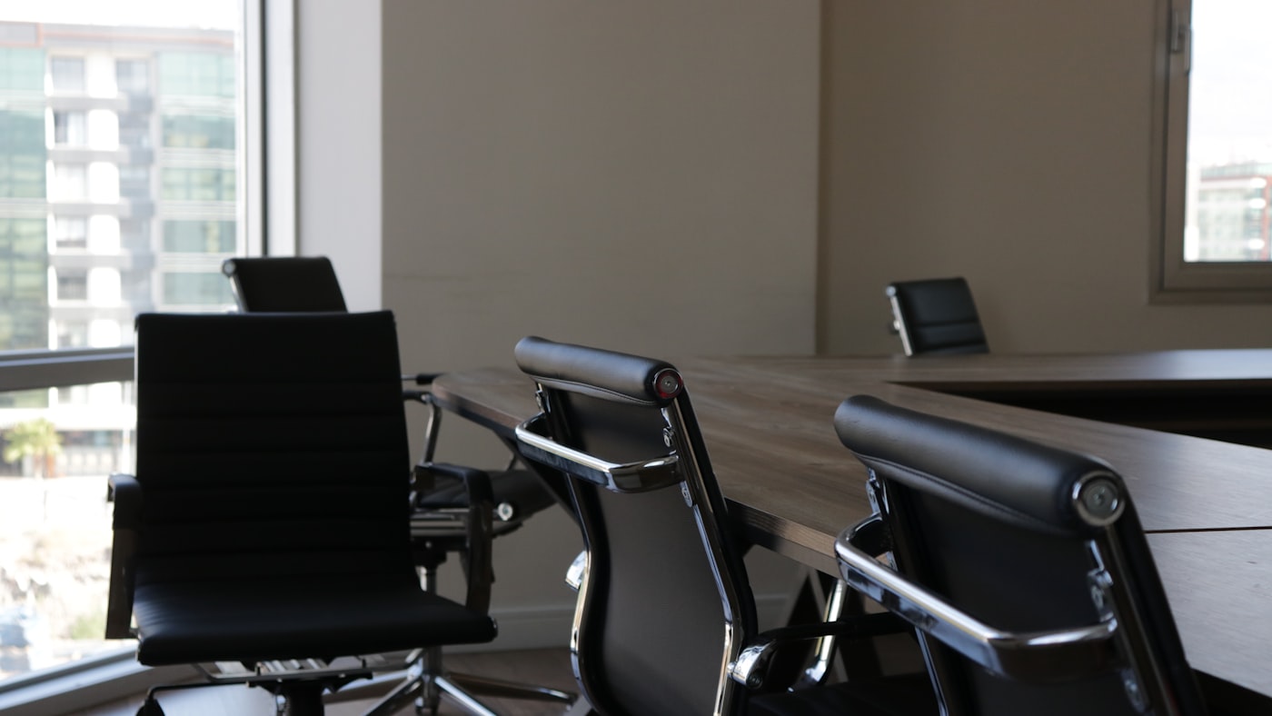 A row of empty desk chairs — the team a solo builder does not have